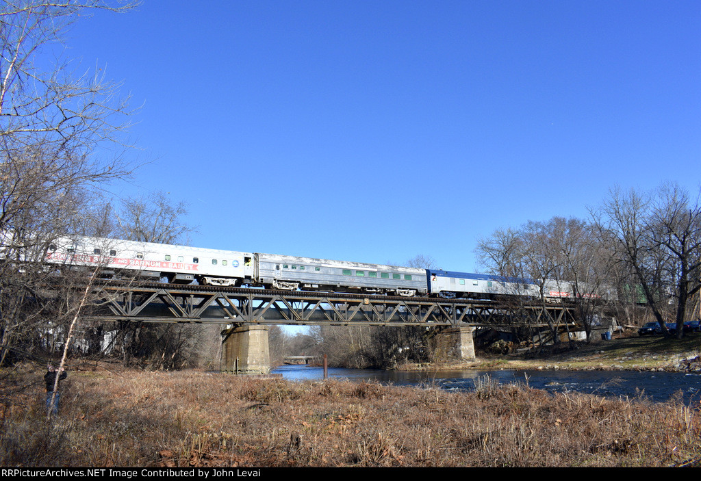 The former coaches and sleeper cars get their turn crossing the bridge